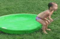 small baby in unsuccessful jump in inflatable pool