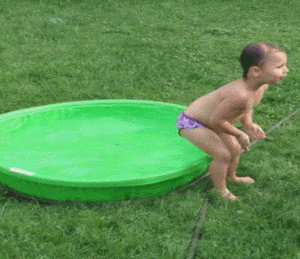 small baby in unsuccessful jump in inflatable pool